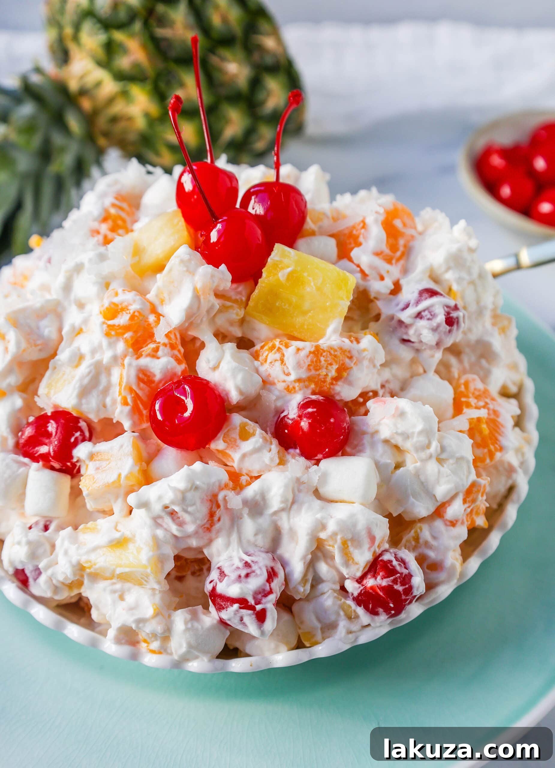 Sweet Ambrosia Cloud 8 A large serving bowl filled with Ambrosia Salad, ready for a festive gathering. The vibrant colors and creamy texture are inviting.