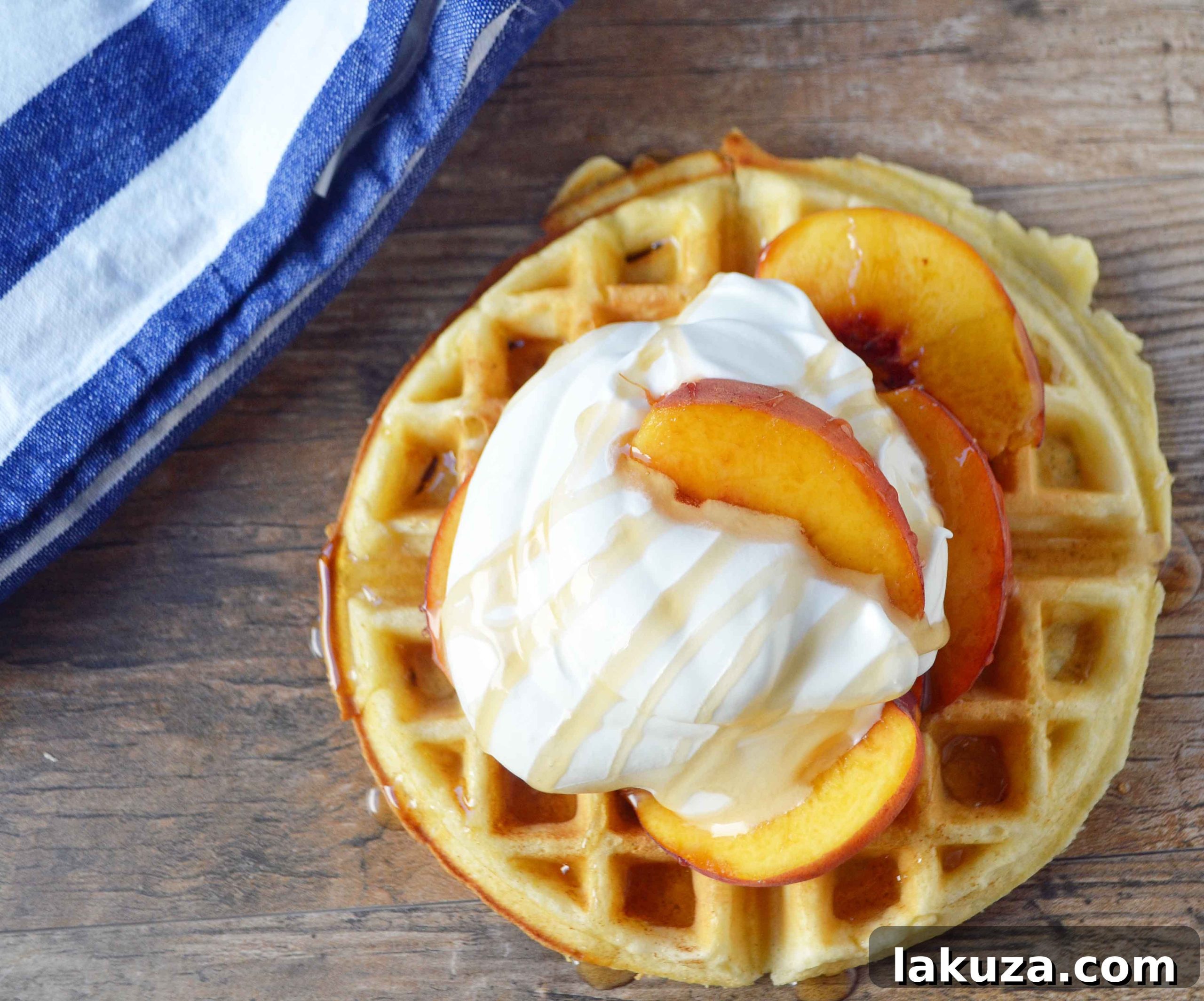 A stack of golden buttermilk waffles with a drizzle of syrup, ready to be served.
