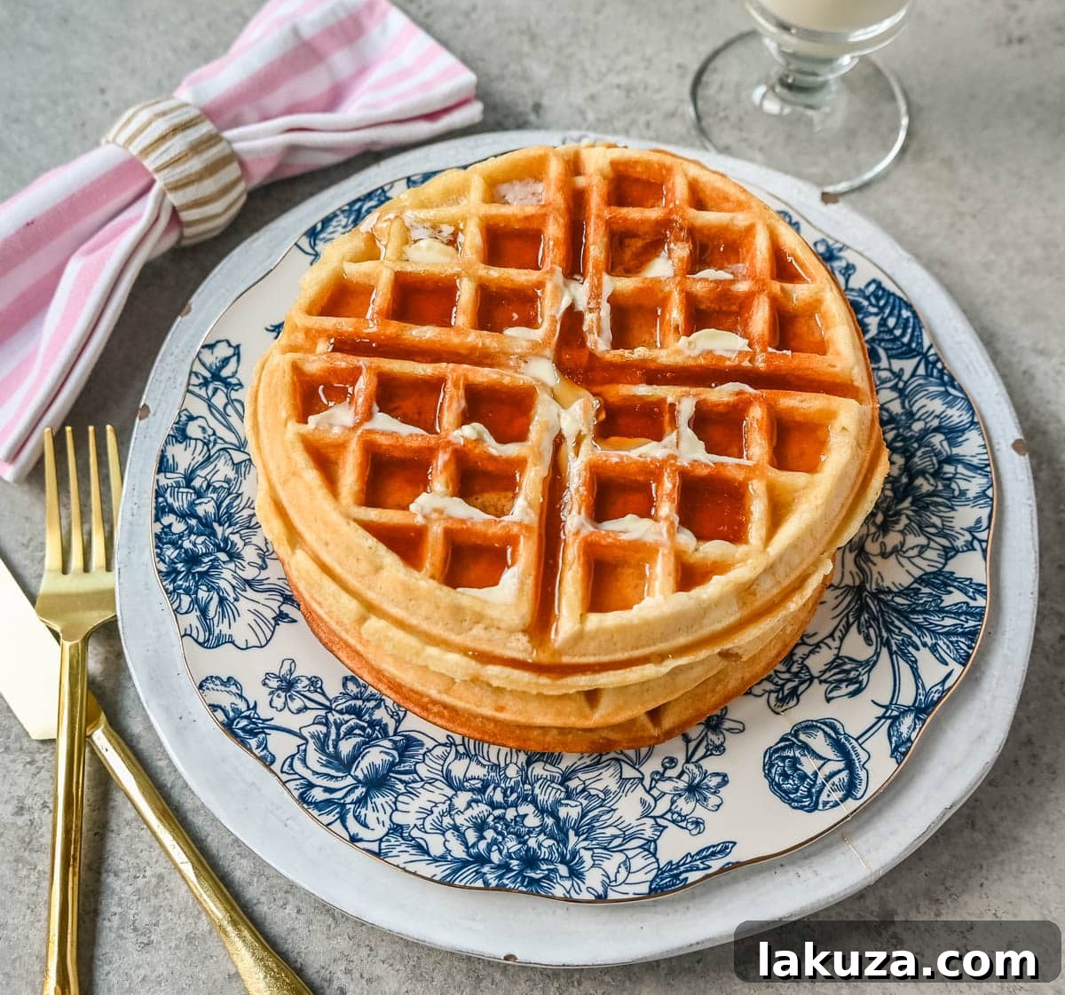 Crispy homemade buttermilk waffles stacked and ready to be served.