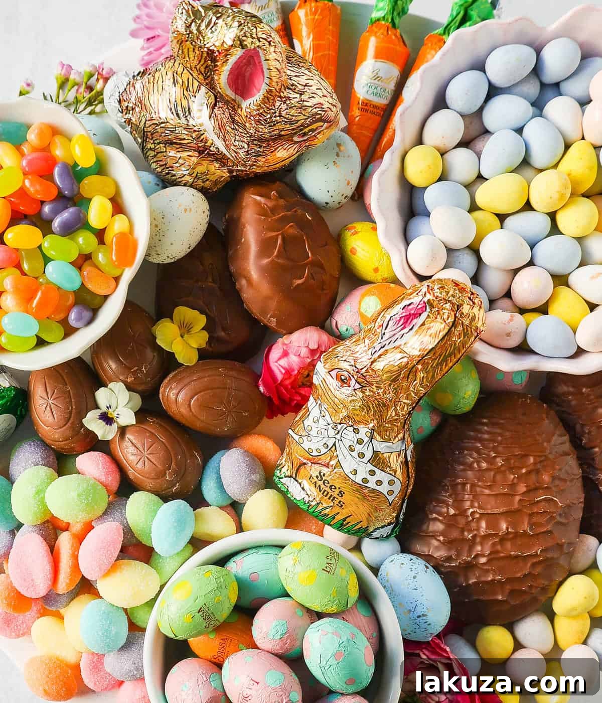 A close-up view of an inviting Easter dessert board, showcasing an assortment of chocolates, gummies, and marshmallow treats arranged artfully.