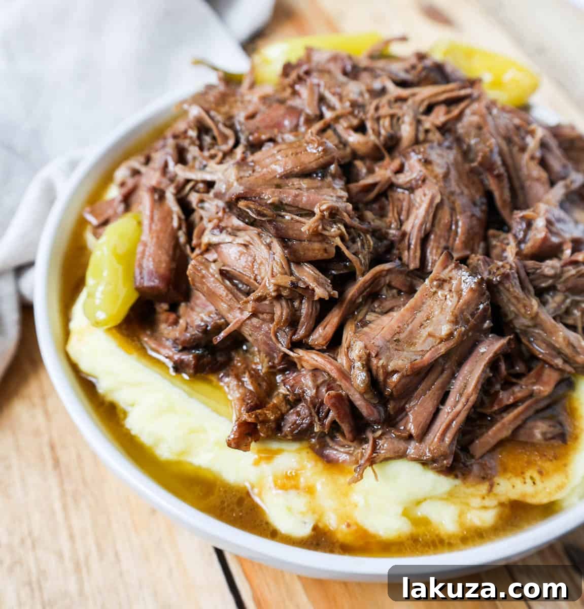 Mississippi Pot Roast served with creamy mashed potatoes, showcasing its tender texture and rich gravy.