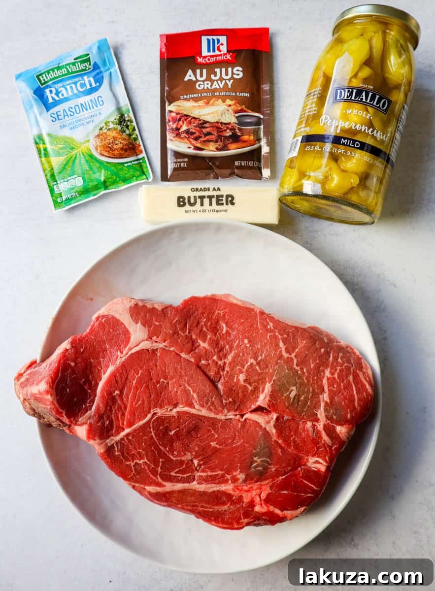 Five key ingredients for Mississippi Pot Roast: chuck roast, ranch powder, au jus mix, pepperoncinis, and butter.