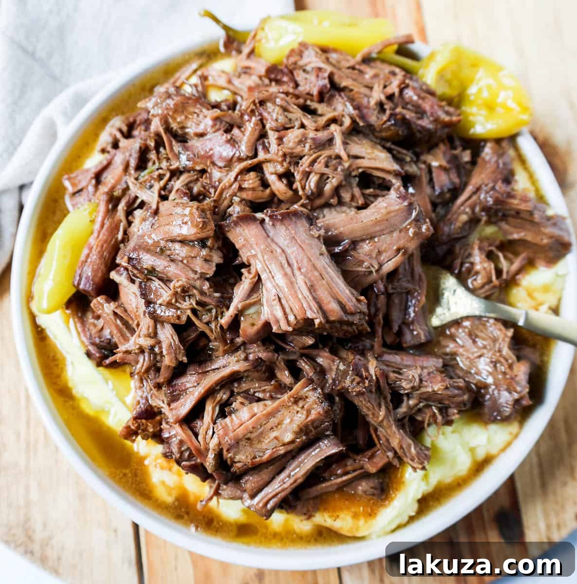 The Mississippi Pot Roast, cooked to tender perfection, being removed from the slow cooker.