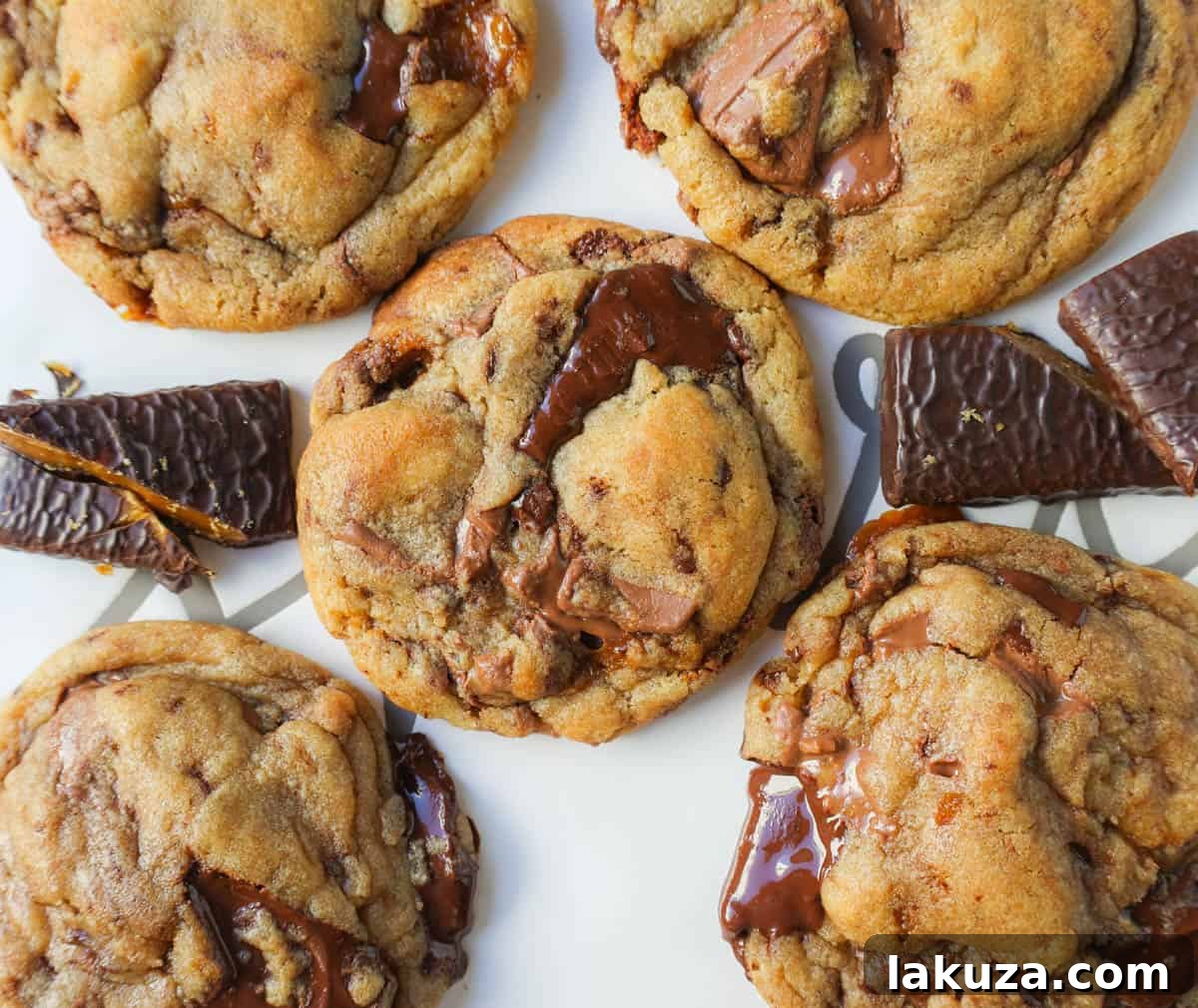 Caramelized Butter Toffee Chip Cookies 11 A close-up shot of a perfectly baked browned butter toffee chocolate chip cookie, highlighting its rich golden color and crisp edges.