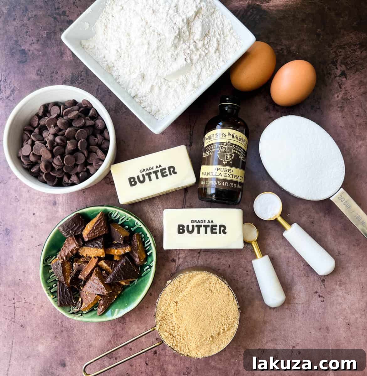 Caramelized Butter Toffee Chip Cookies 4 All the ingredients neatly laid out for making browned butter toffee chocolate chip cookies, including butter, sugars, eggs, flour, chocolate chips, and toffee bits.