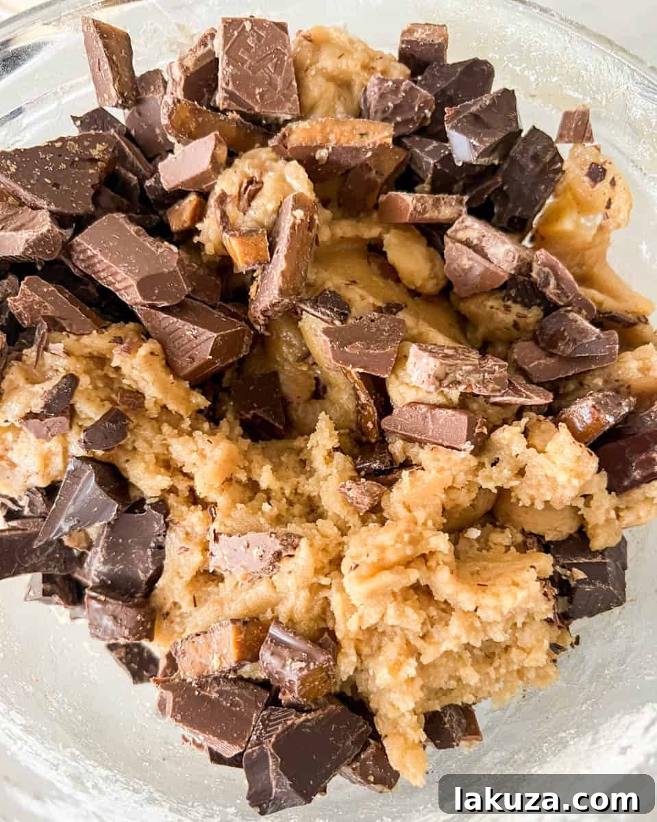 Caramelized Butter Toffee Chip Cookies 9 Cookie dough generously studded with chocolate chunks and toffee bits, ready to be chilled.