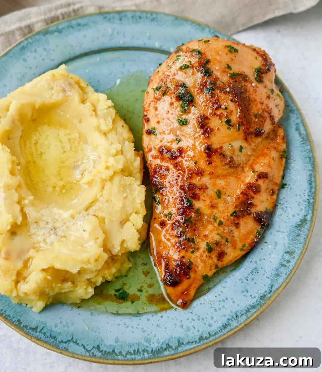 Close-up of baked chicken, showing its golden-brown crust and juicy texture.