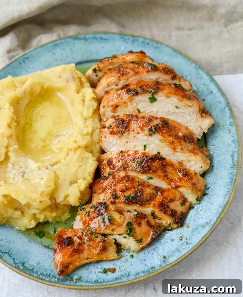 Raw chicken breasts seasoned with the homemade spice rub, ready for baking.