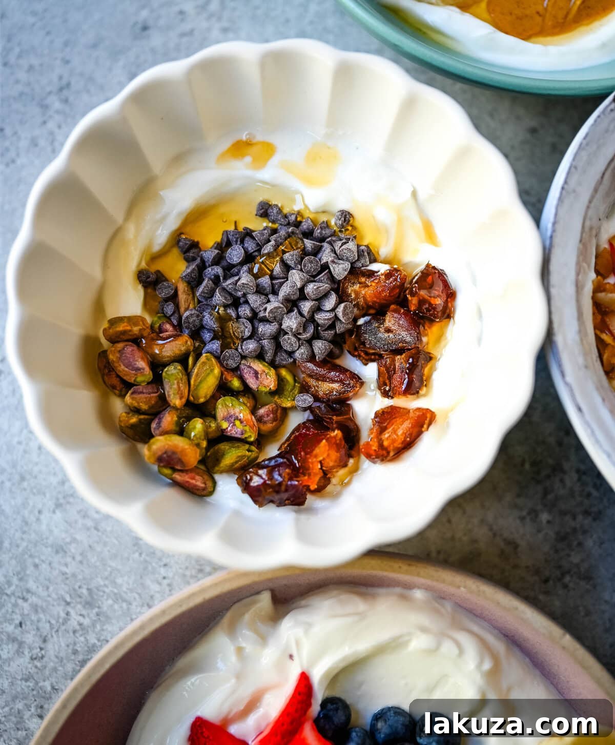 Dubai chocolate yogurt bowl. Greek yogurt, pistachios, dates, chocolate chips.