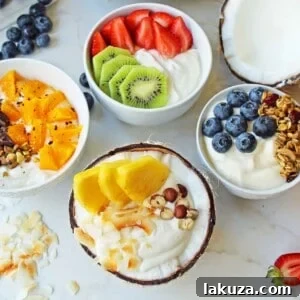 Greek Yogurt Breakfast Bowls with Toppings by Modern Honey. Healthy Greek Yogurt topped with fresh fruits, nuts, and honey. It's a perfect breakfast to start the day!
