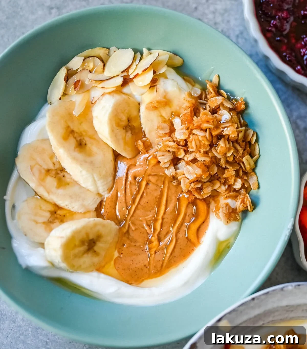 Chunky Monkey Greek Yogurt Bowl. Greek yogurt, peanut butter, bananas, granola, almonds, chocolate chips.