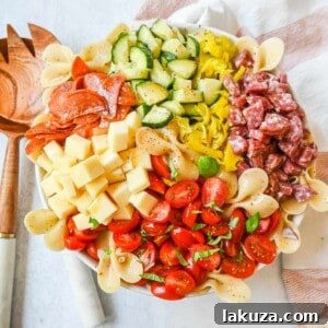 A top-down view of the freshly prepared Italian Pasta Salad, glistening with dressing and adorned with fresh herbs, ready for serving.