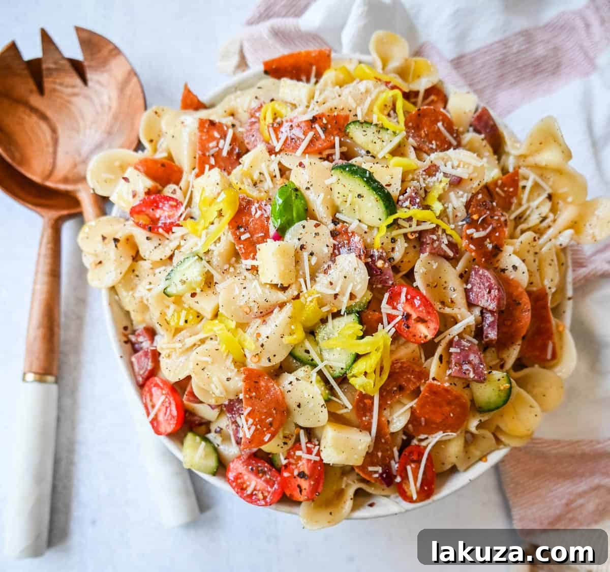Zesty Italian Pasta Medley 3 Another appealing shot of the Italian Pasta Salad, showing a wider view of the bowl, perfectly mixed and ready for serving. The composition highlights the abundance of ingredients and the inviting texture of the dressing.
