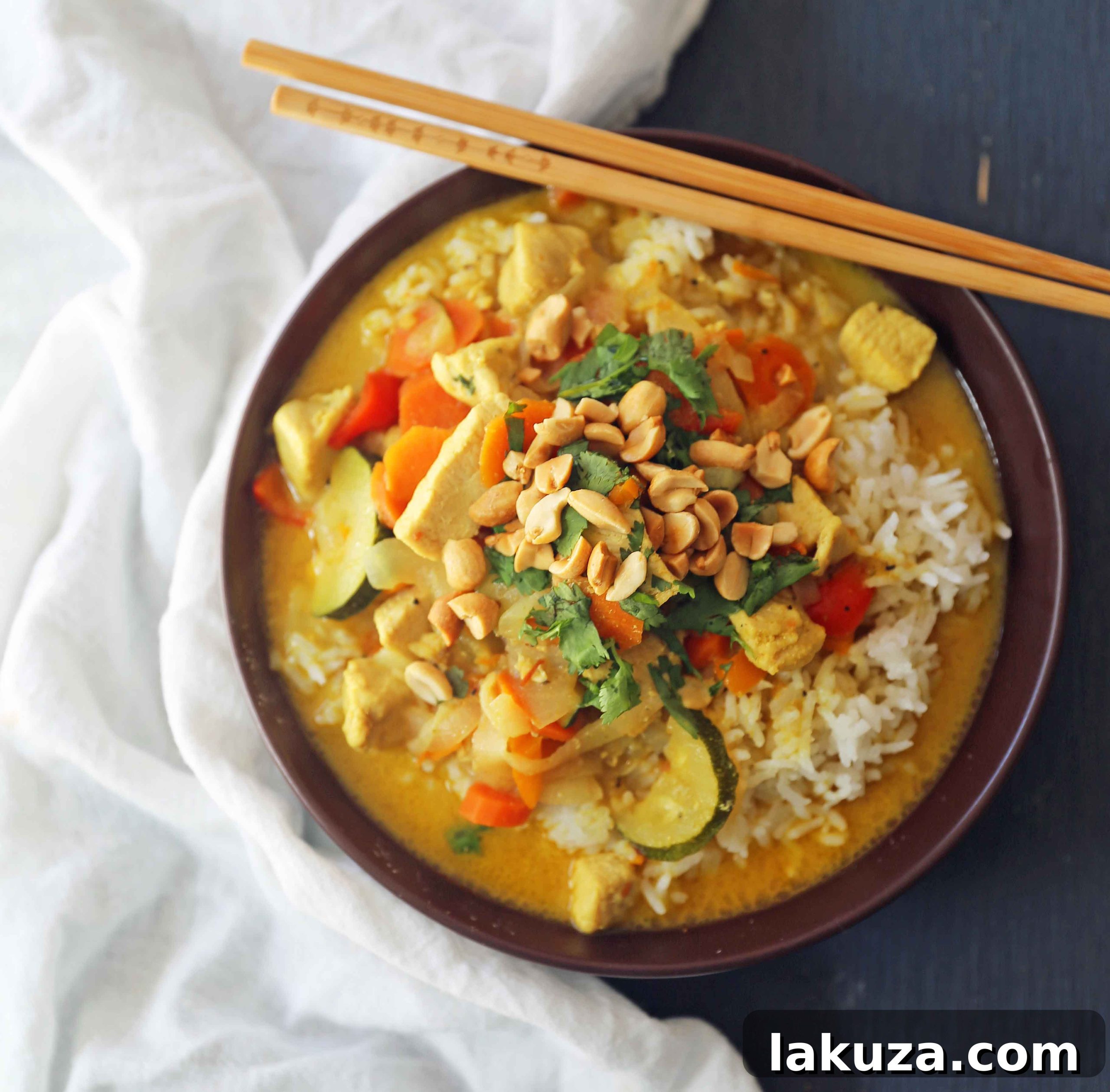 Golden Thai Chicken Curry Bowls 3 A close-up shot of a steaming bowl of Thai Green Chicken Curry, showcasing chunks of chicken and colorful vegetables. This healthy, gluten-free, and dairy-free curry is a perfect blend of comfort and flavor for any meal.