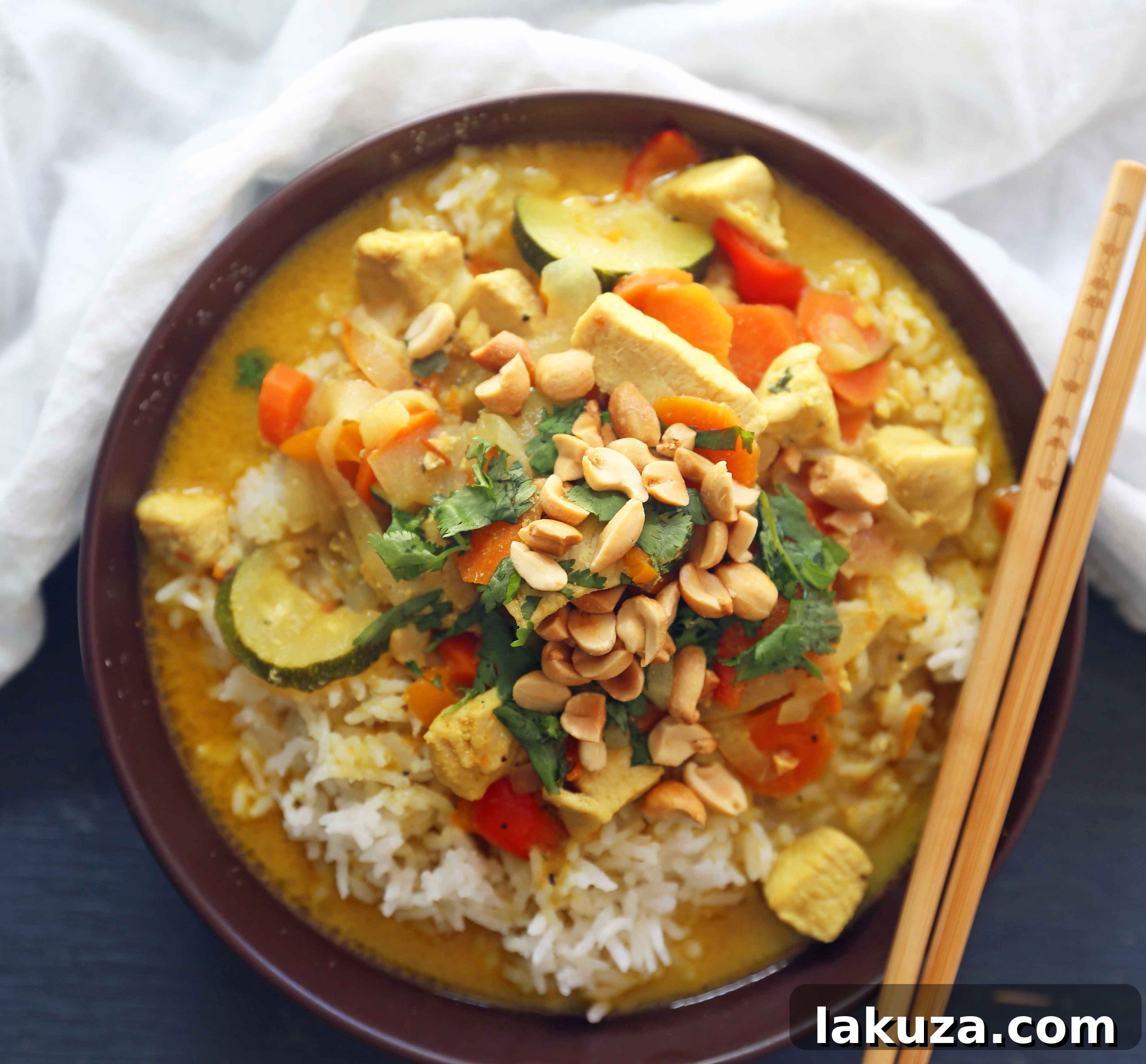 Golden Thai Chicken Curry Bowls 5 An overhead shot of Thai Green Chicken Curry, with tender chicken pieces, colorful veggies, and a creamy coconut sauce. This healthy, gluten-free, and dairy-free curry recipe is quick to make and bursting with authentic Thai flavors.