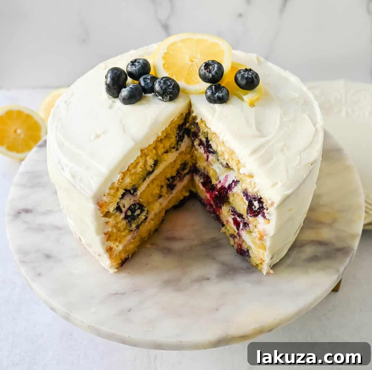 Ingredients laid out for baking a lemon blueberry cake, including fresh lemons and blueberries