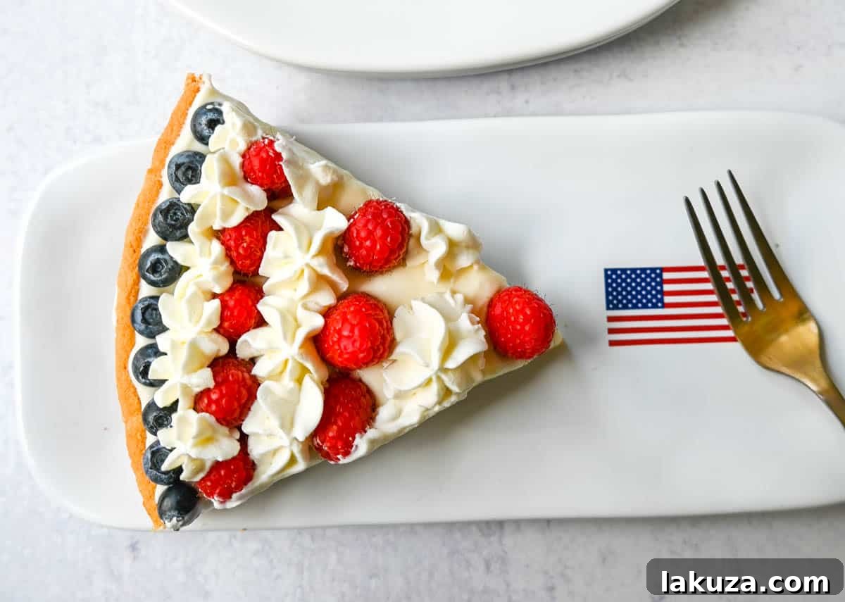 Another appealing shot of the finished Sugar Cookie Flag Fruit Pizza, ready to be served at a 4th of July celebration.