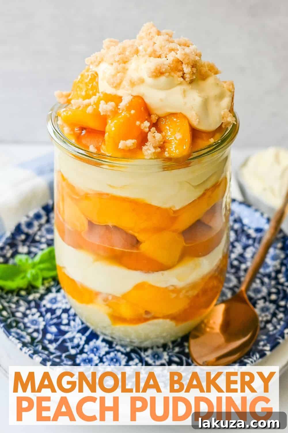 Serving of Magnolia Bakery Peach Crisp Pudding with a full trifle in the background.