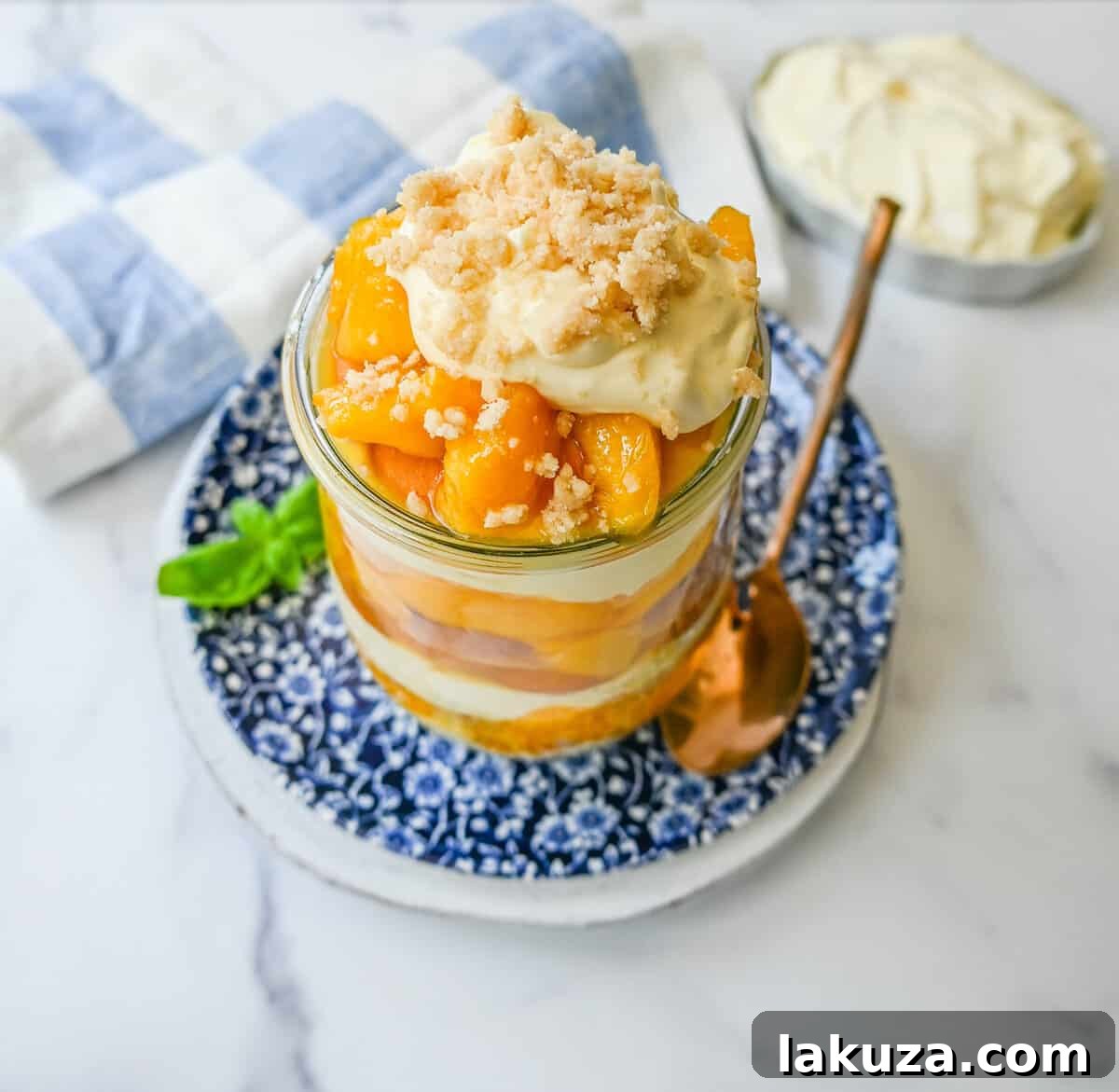 Close-up of a serving of Magnolia Bakery Peach Crisp Pudding, highlighting the layers.