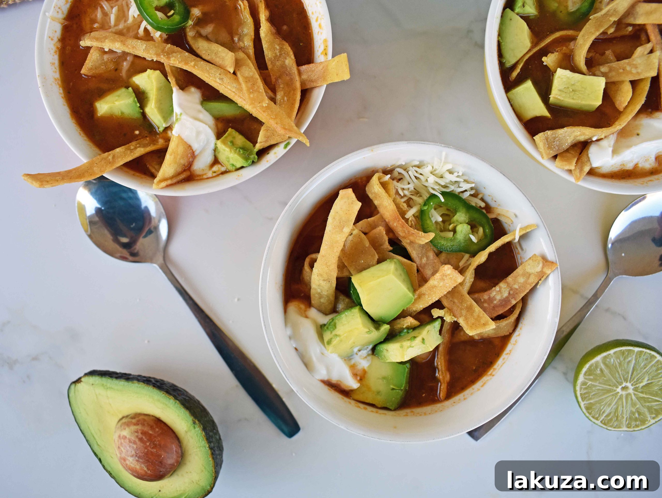 A close-up of the rich, simmering broth of Chicken Tortilla Soup, ready to be served, promising deep and satisfying flavors.