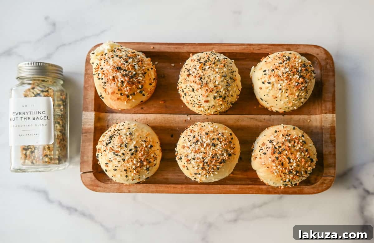 A close-up of freshly baked Everything Bagel Cream Cheese Bites arranged neatly, showcasing their fluffy texture and enticing seasoning, perfect for a quick and satisfying snack or breakfast.
