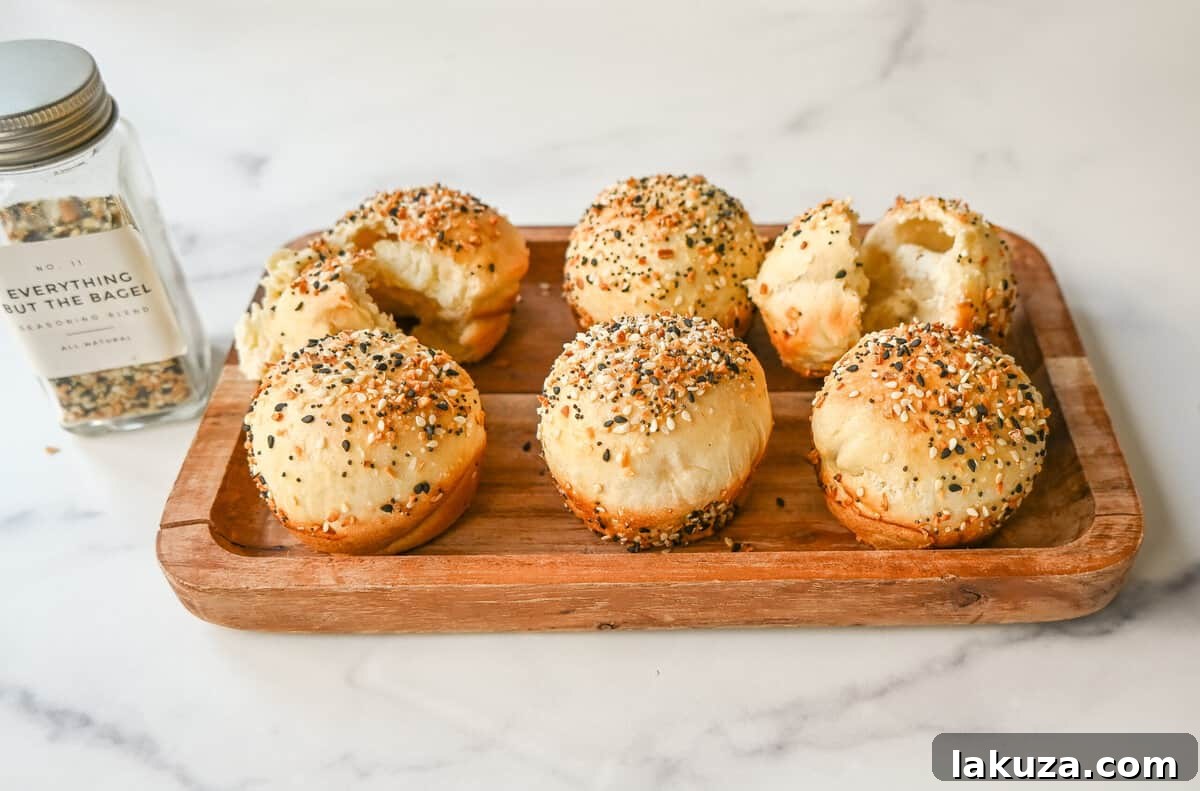 A close-up showing the process of placing generous cream cheese filling into the center of a flattened Everything Bagel Cream Cheese Bite dough before sealing, emphasizing the key step for delicious results.