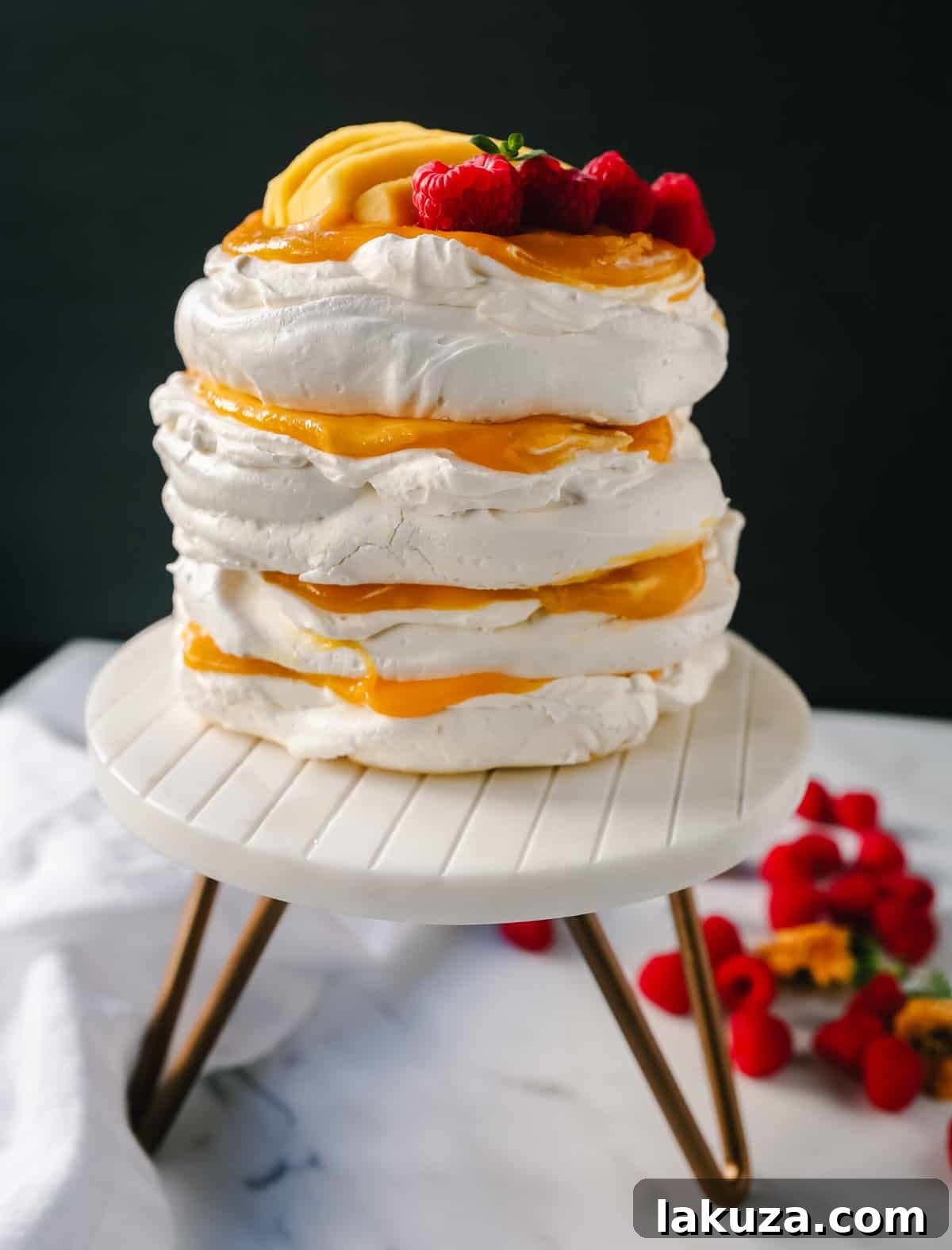 A vibrant Pavlova topped with an assortment of fresh berries, ready to be served.