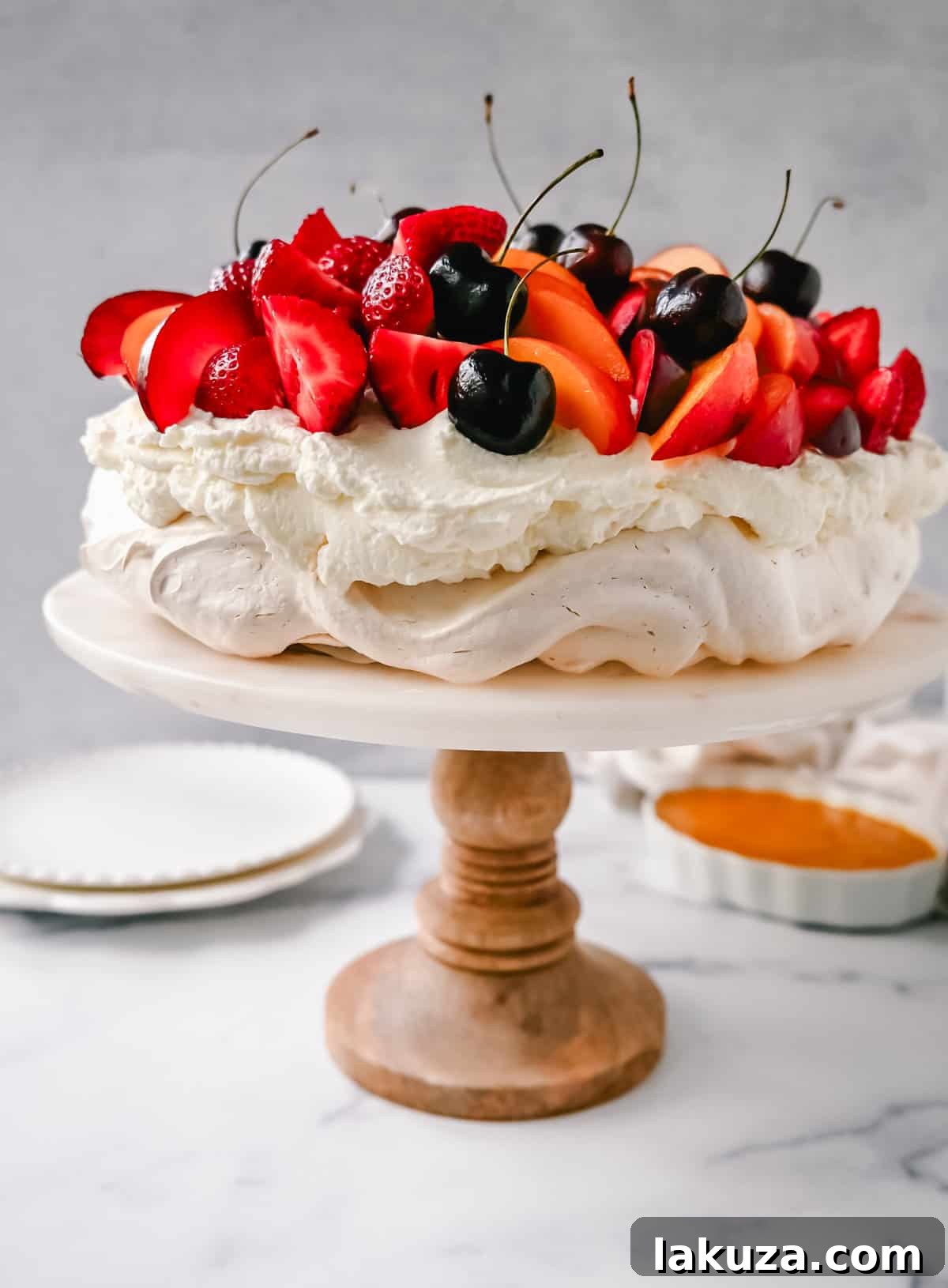 A slice of Pavlova showing its layered beauty with cream and mixed fruits.