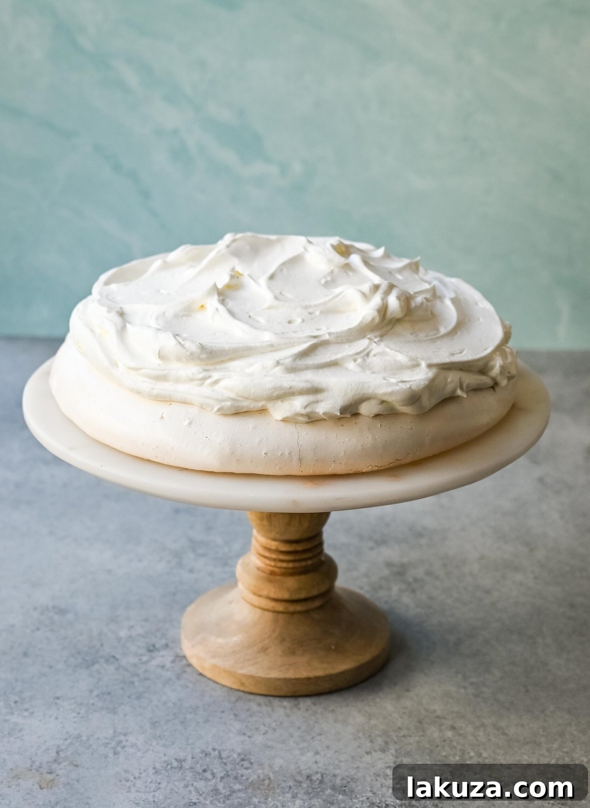 A perfect Pavlova, intact and ready for toppings, illustrating the success of careful baking.