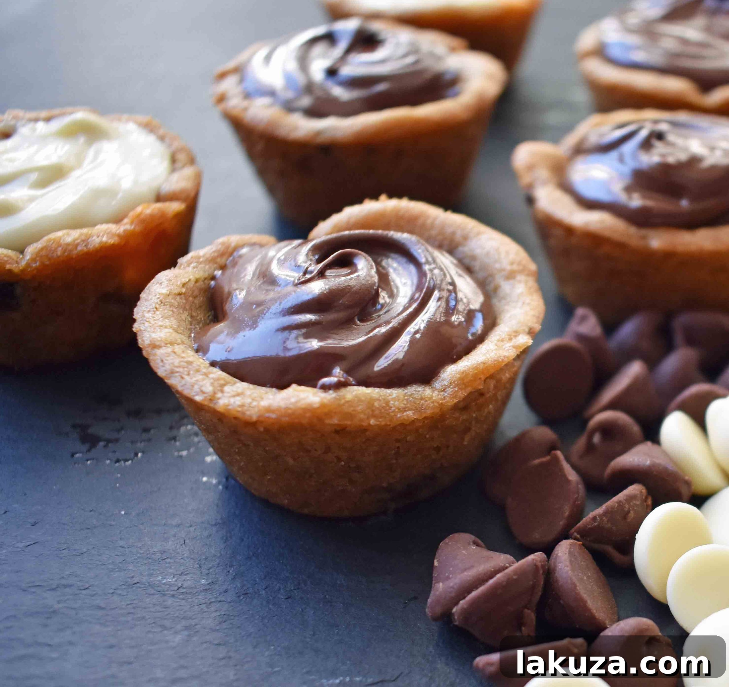 A tray of perfectly formed Chocolate Ganache Filled Cookie Cups, created using Modern Honey's method, showcasing their inviting appearance.