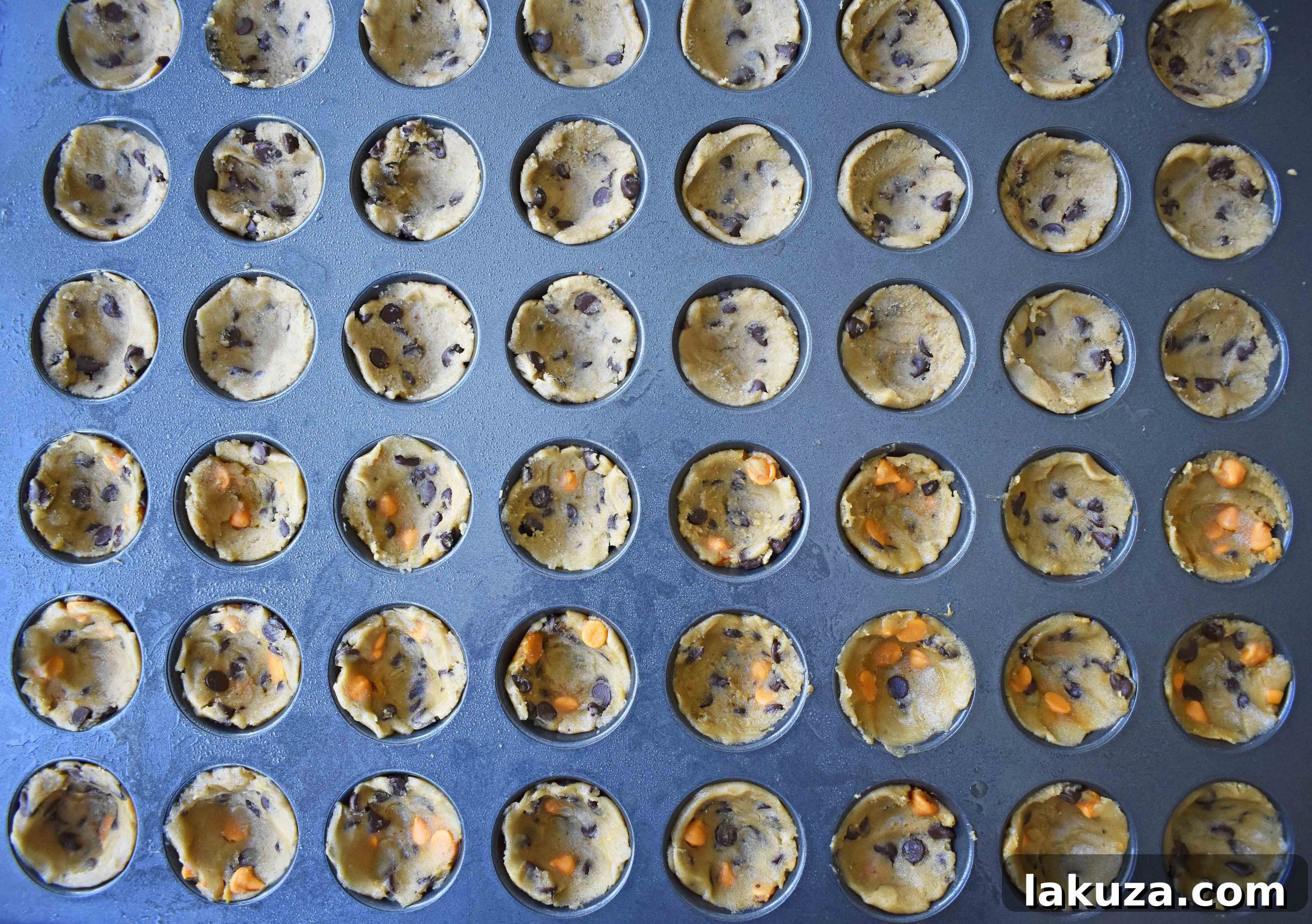 Step-by-step: Illustrating the technique of pressing cookie dough into a mini cupcake pan to create the ideal cup shape for filling.