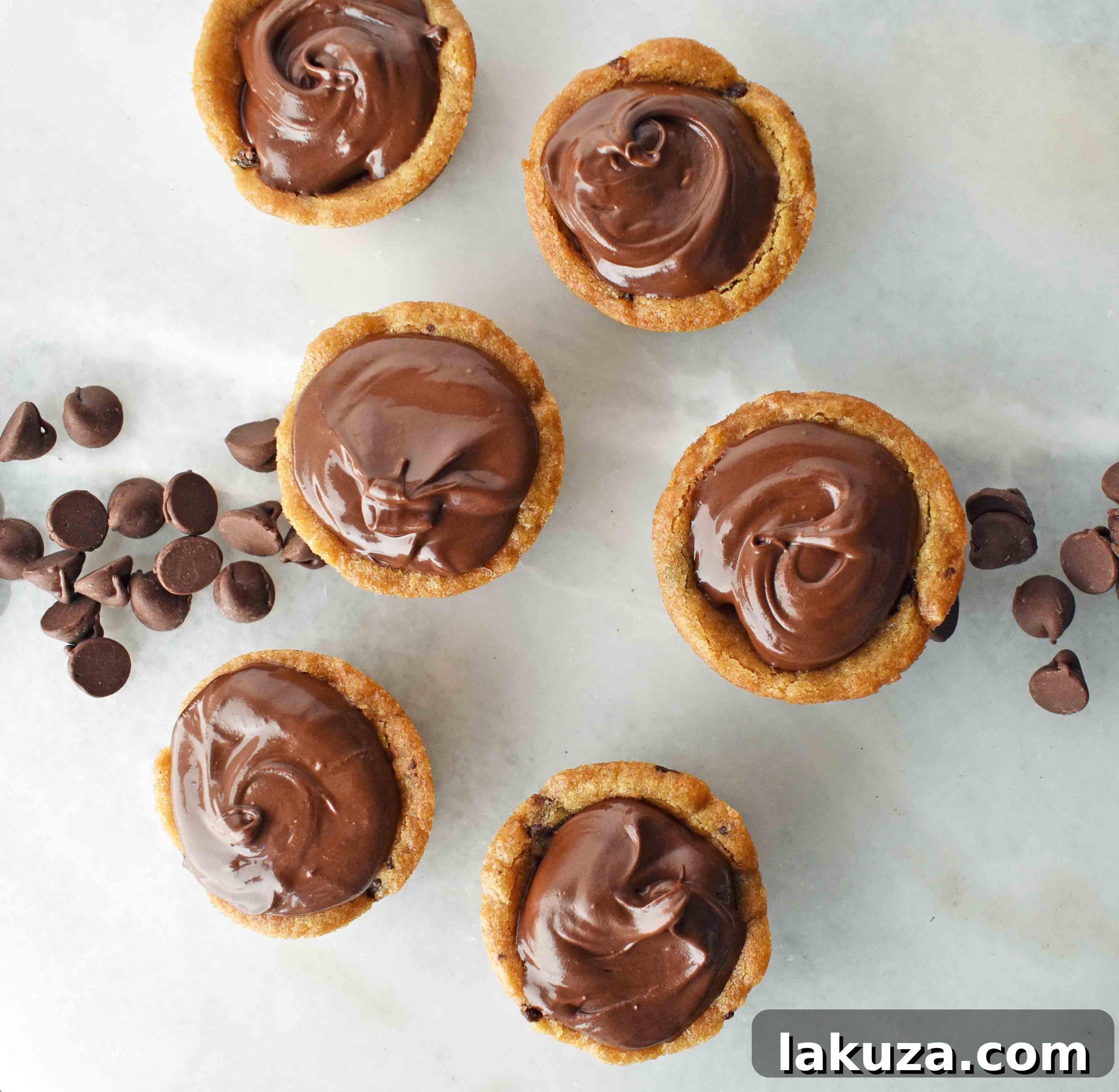 A dazzling display of finished Chocolate Ganache Filled Cookie Cups, adorned with elegant chocolate swirls, ready to delight any palate.