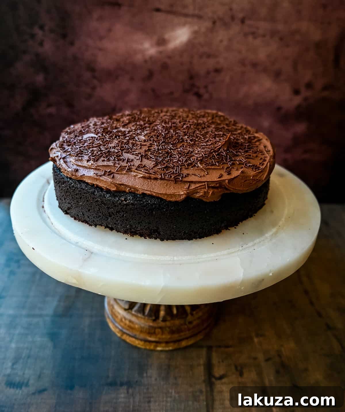 Close-up of a slice of Chocolate Olive Oil Cake, showcasing its moist texture and rich chocolate buttercream.