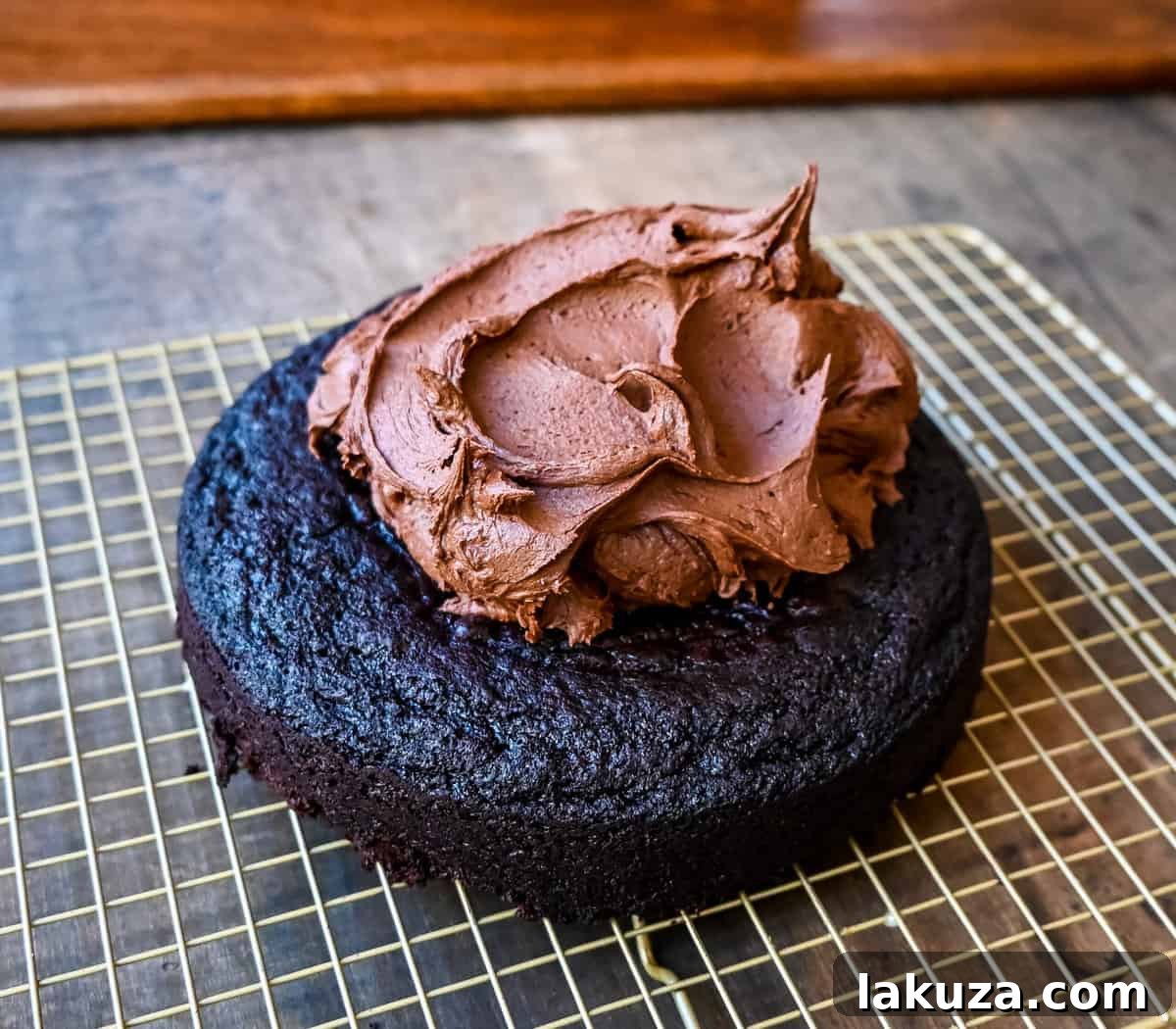 Finished Chocolate Olive Oil Cake with a generous layer of homemade chocolate buttercream frosting.