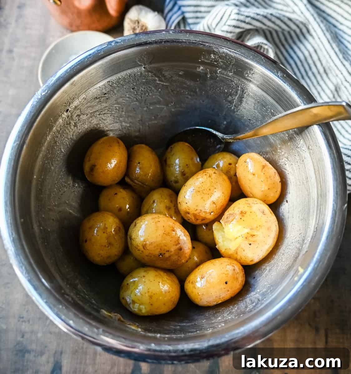Loaded Bacon Cheddar Smashed Potatoes tossed in butter and olive oil.