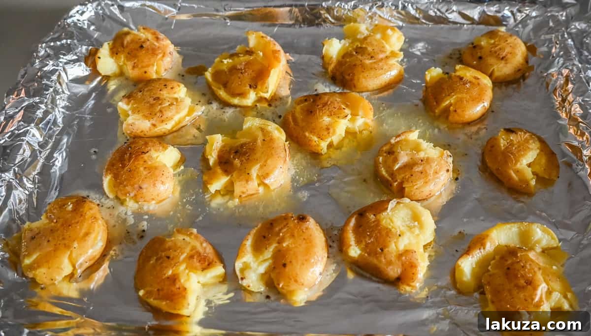 Crispy Smashed Potatoes on a baking sheet, ready for toppings.