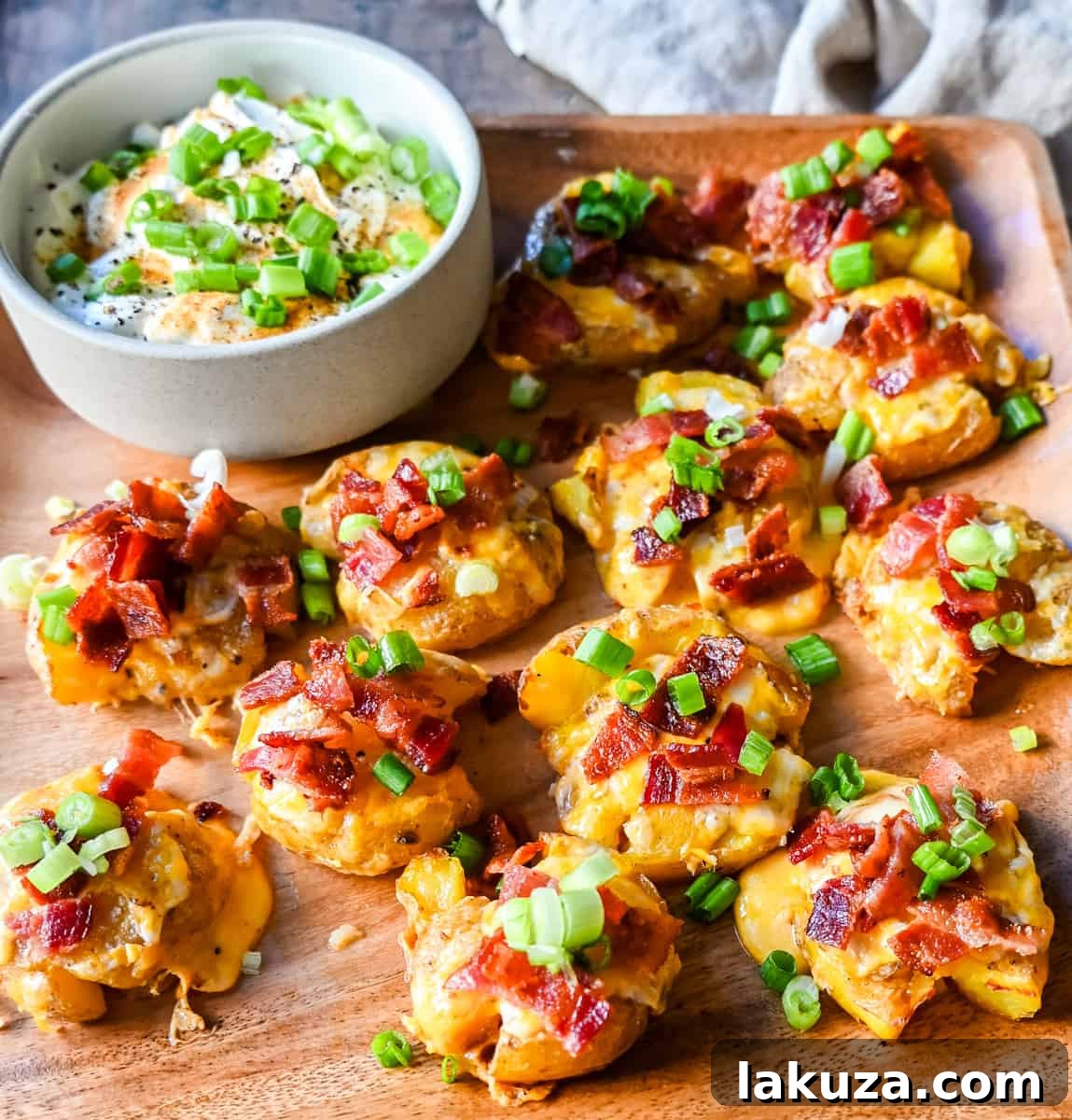 Loaded Bacon Cheddar Smashed Potatoes. Crispy and buttery smashed potatoes topped with bacon, cheddar cheese, and green onions. The perfect side dish.