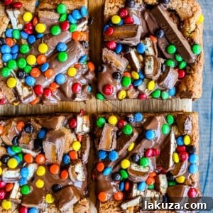 Ultimate Candy Bar Blondies 10 Candy Bar Cookie Bars. An ooey gooey cookie bar topped with an assortment of candy bars. The perfect candy bar blondie dessert to make with Halloween candy.