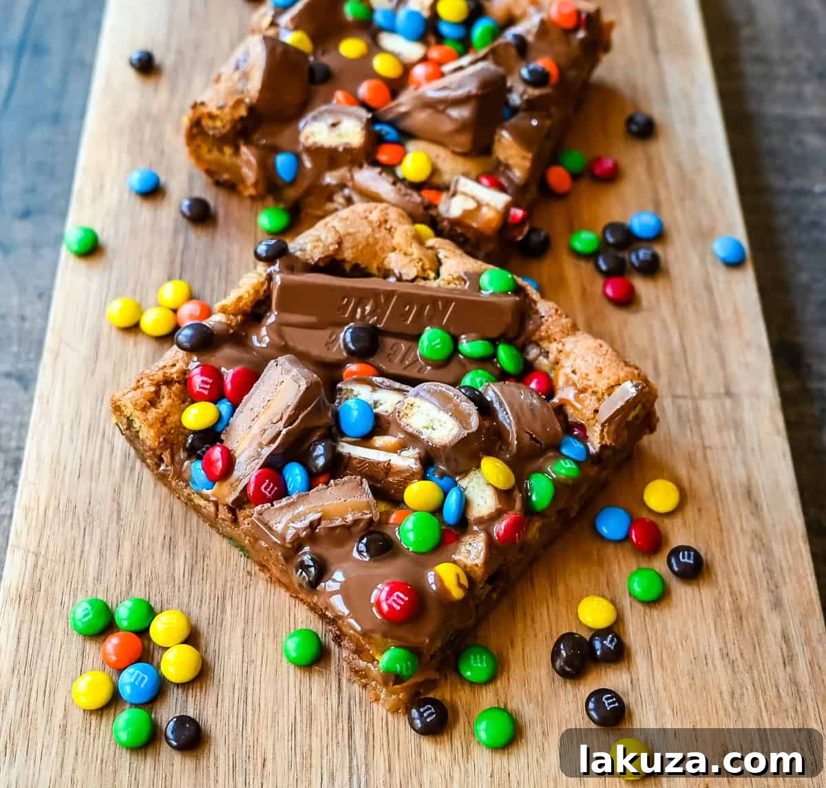 Ultimate Candy Bar Blondies 5 An ooey gooey cookie bar topped with an assortment of candy bars. The perfect candy bar blondie dessert to make with Halloween candy.