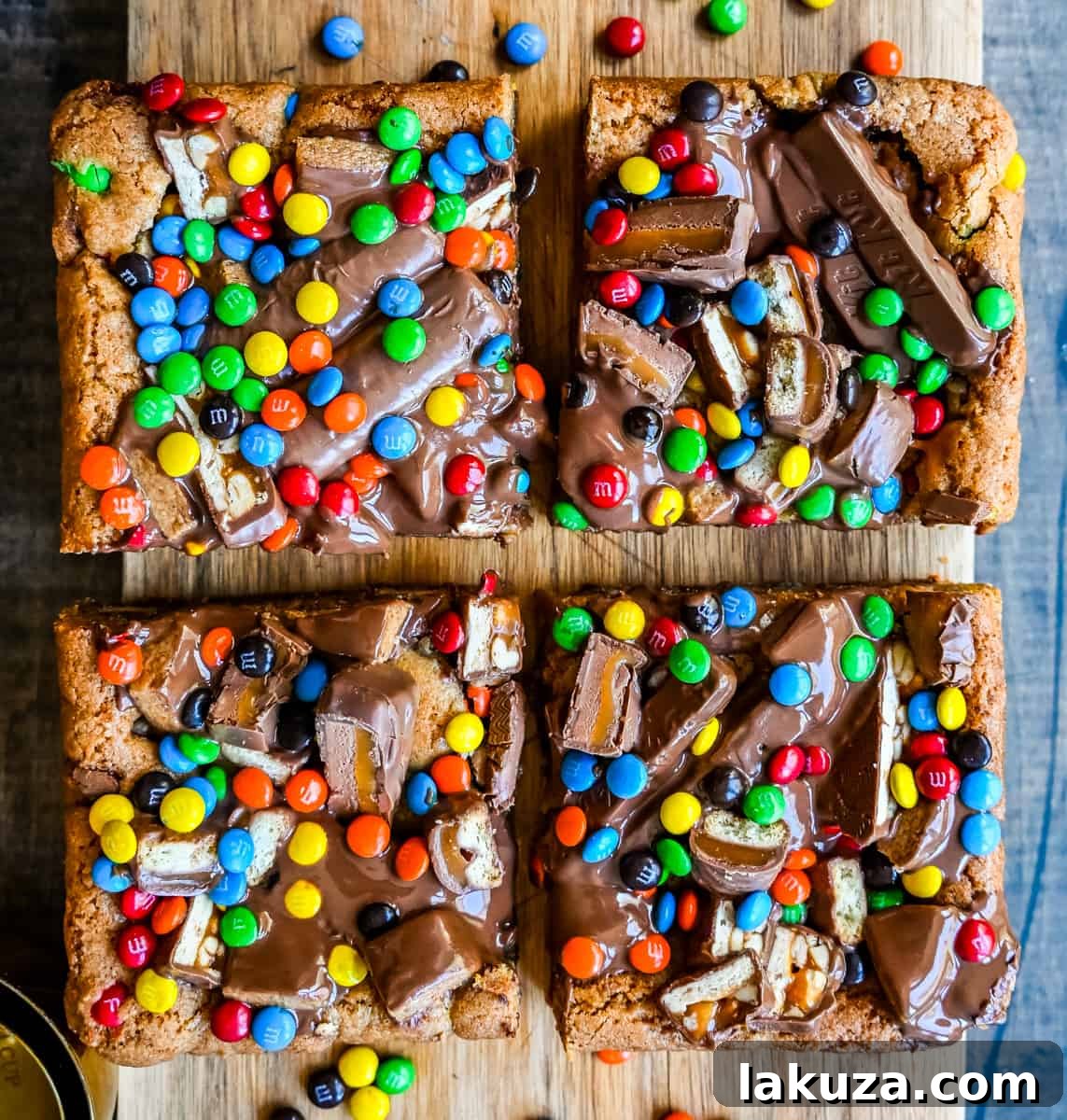 Ultimate Candy Bar Blondies 7 An ooey gooey cookie bar topped with an assortment of candy bars. The perfect candy bar blondie dessert to make with Halloween candy.