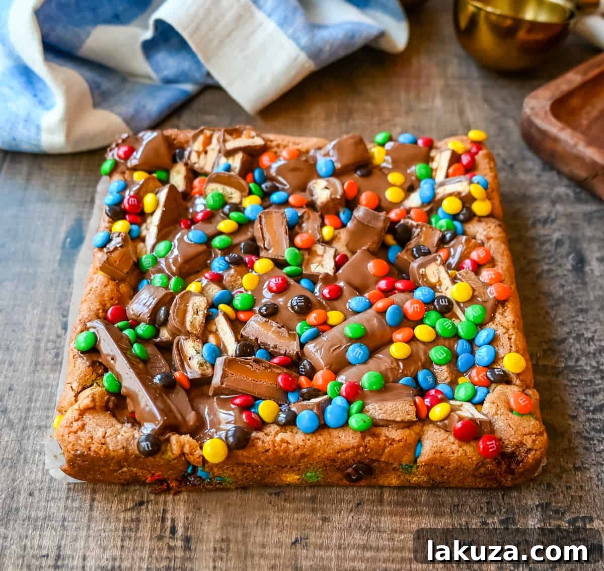 Ultimate Candy Bar Blondies 8 An ooey gooey cookie bar topped with an assortment of candy bars. The perfect candy bar blondie dessert to make with Halloween candy.