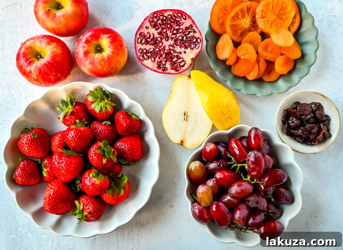 Creating a Showstopping Charcuterie Board 10 A vibrant selection of fresh fruits, including red and green grapes, bright oranges, and juicy berries, artfully arranged for a charcuterie board.