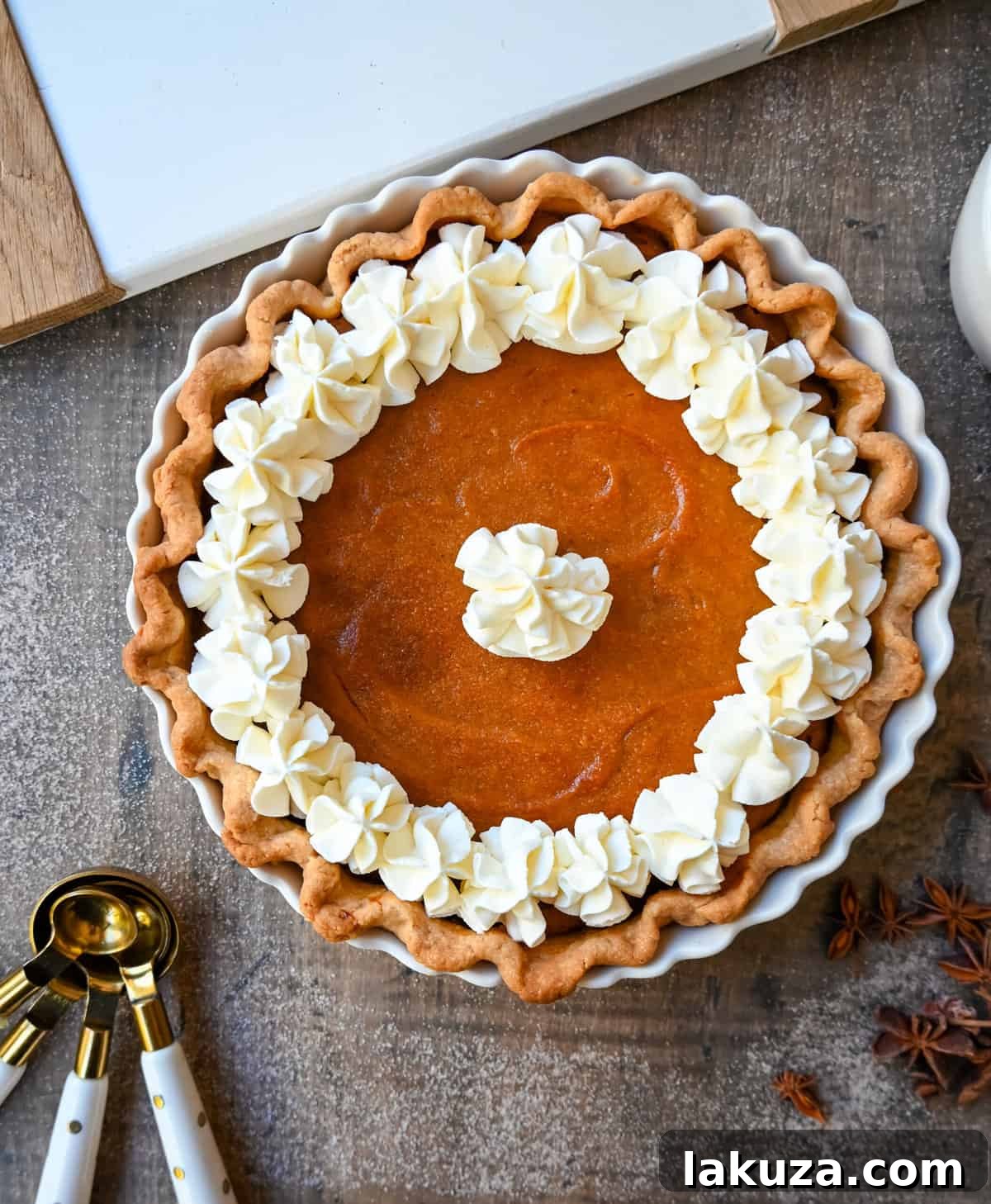 The creamiest Southern Sweet Potato Pie, perfect for Fall and Thanksgiving desserts. Features a spiced brown sugar filling in a buttery crust, topped with fresh whipped cream.