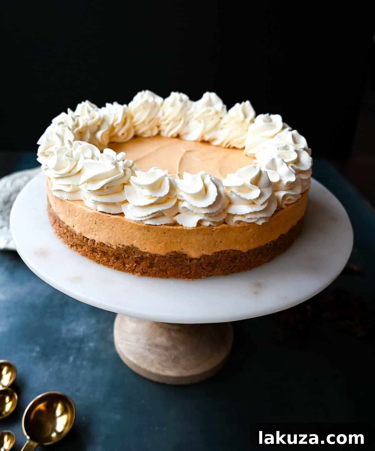 Effortless Pumpkin Cheesecake 4 The smooth, creamy pumpkin cheesecake filling being folded with whipped cream in a large mixing bowl.