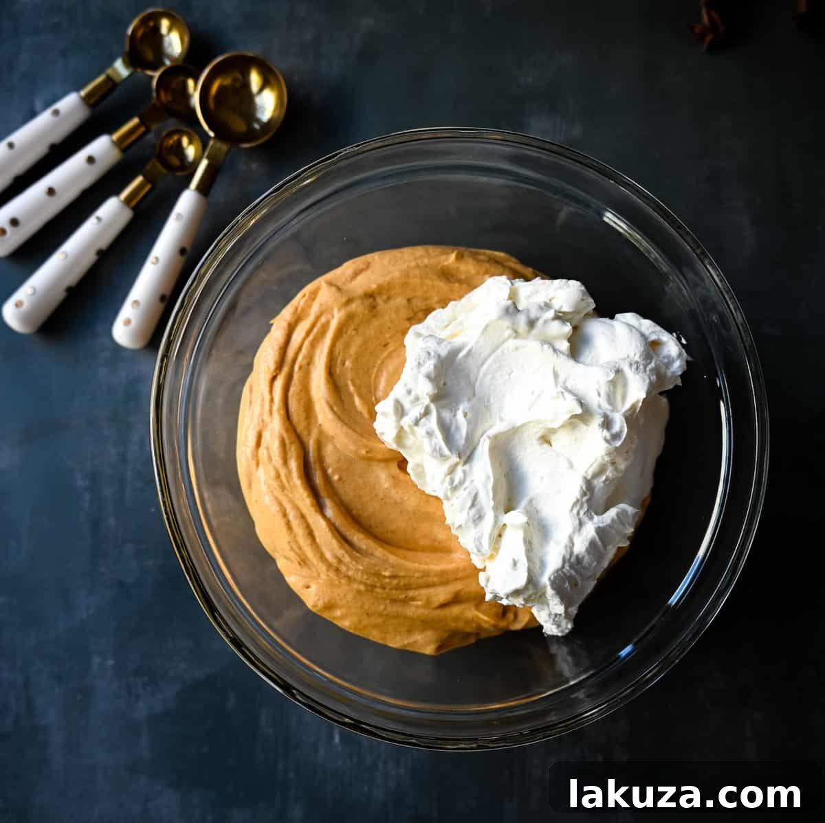 Effortless Pumpkin Cheesecake 5 Close-up of the smooth, unbaked pumpkin cheesecake filling in a bowl, ready to be spread into the crust.