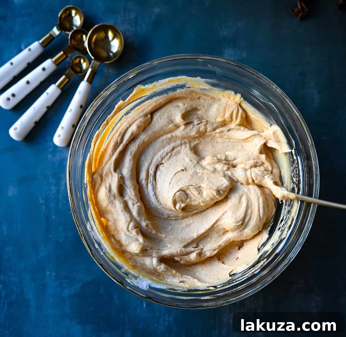 Effortless Pumpkin Cheesecake 6 No-Bake Pumpkin Cheesecake filling in a springform pan, smoothed out and ready for chilling.