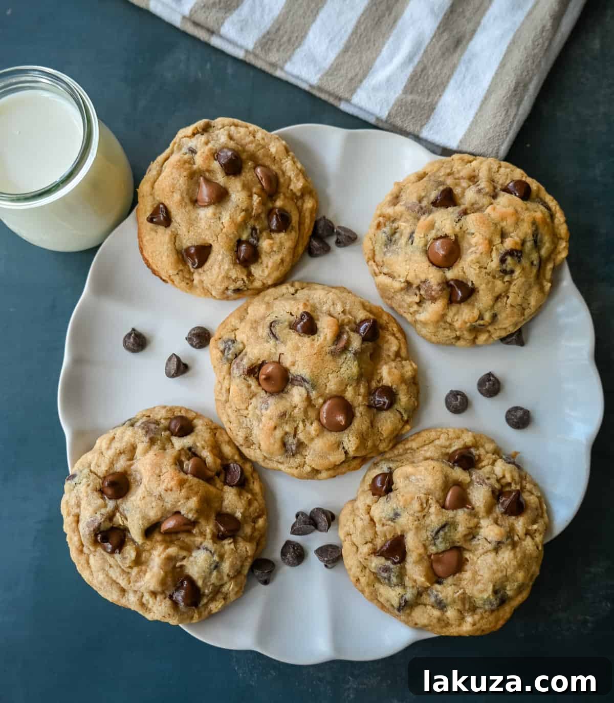 Signature Bakery Oatmeal Chocolate Chip Cookies 4 Freshly baked oatmeal chocolate chip cookies on a cooling rack.