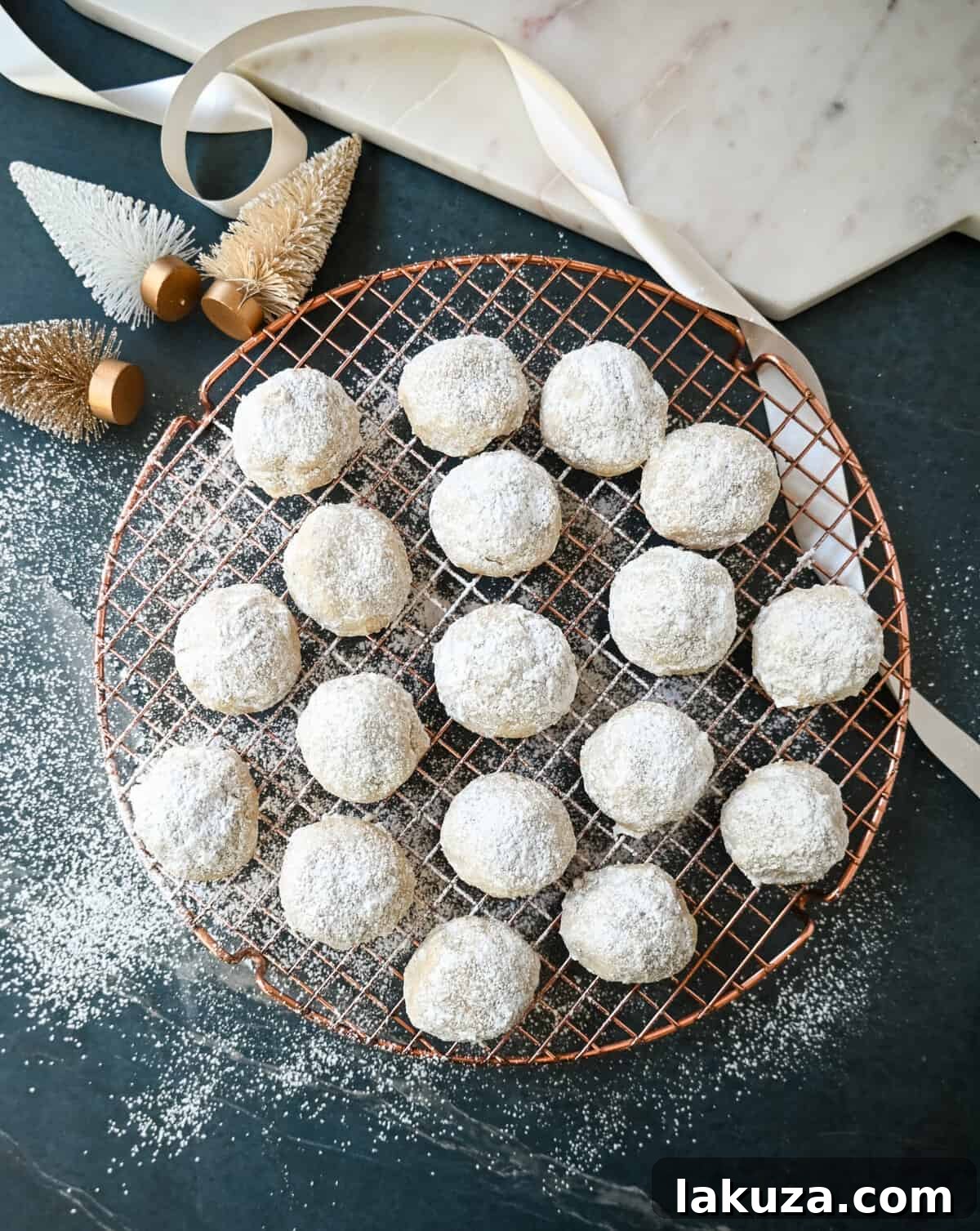 Elegant Pecan Snowball Cookies 7 A festive plate of Mexican Wedding Cookies (Snowball Cookies) dusted with powdered sugar, ready for holiday enjoyment.