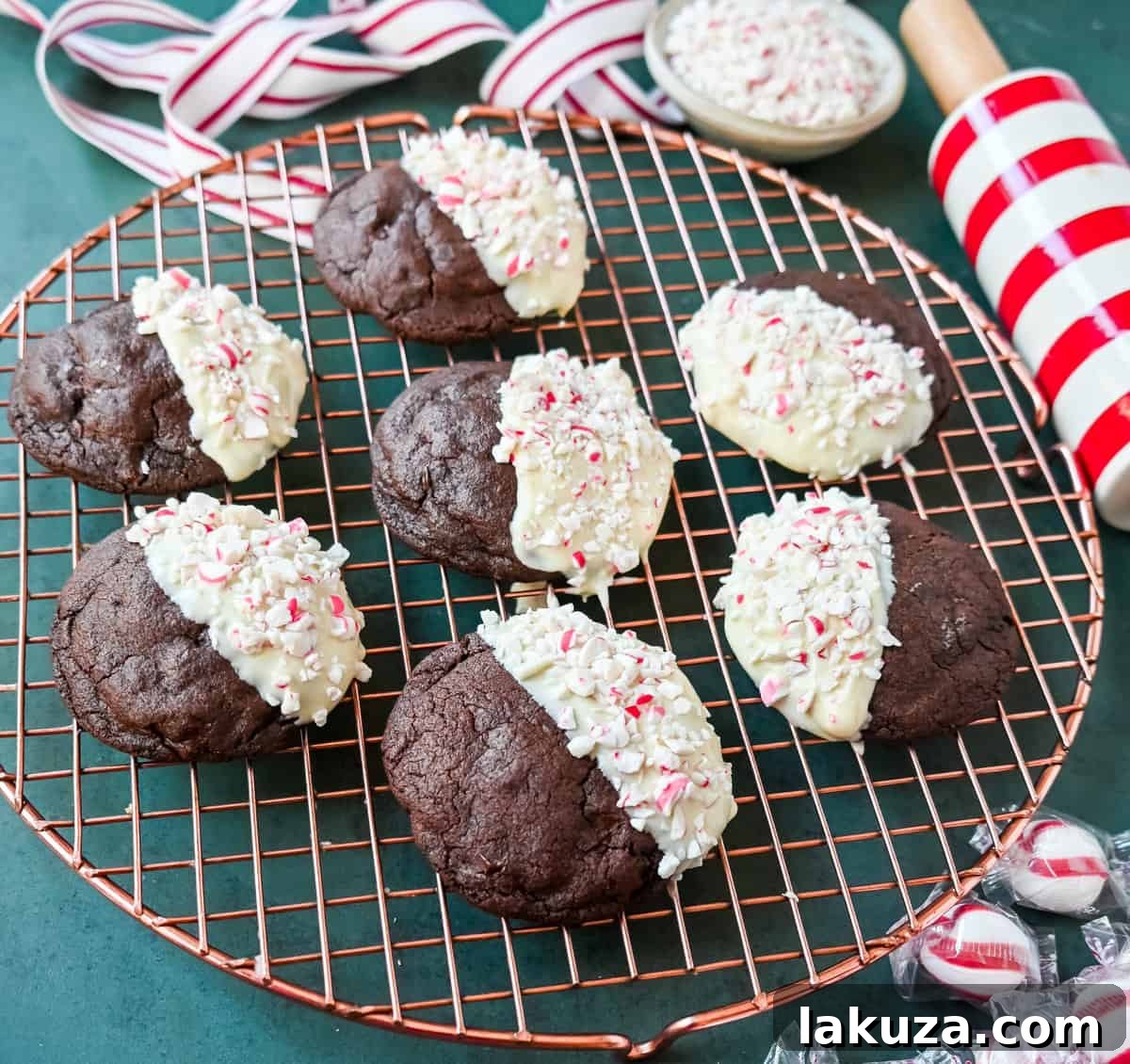White Chocolate Dipped Peppermint Chocolate Cookies. The Double Chocolate Peppermint Cookies are soft baked, rich double chocolate brownie cookies dipped in white chocolate and covered with peppermint candy canes. The perfect Christmas holiday cookie recipe.