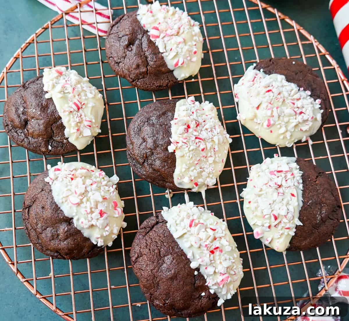 White Chocolate Dipped Peppermint Chocolate Cookies. The Double Chocolate Peppermint Cookies are soft baked, rich double chocolate brownie cookies dipped in white chocolate and covered with peppermint candy canes. The perfect Christmas holiday cookie recipe.